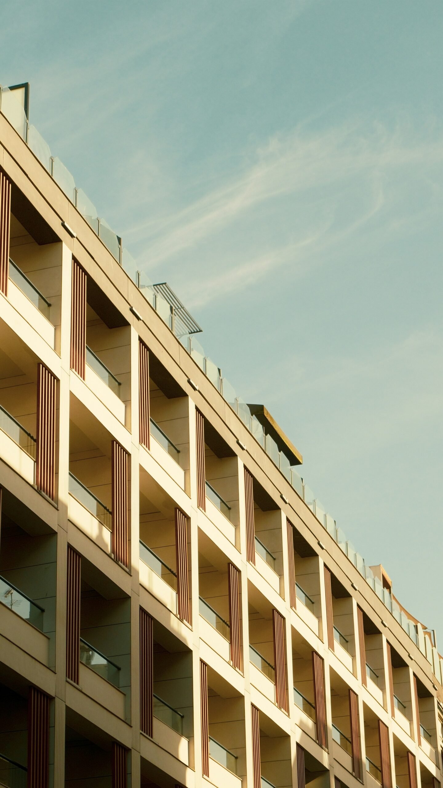 A tall building with balconies on the top of it